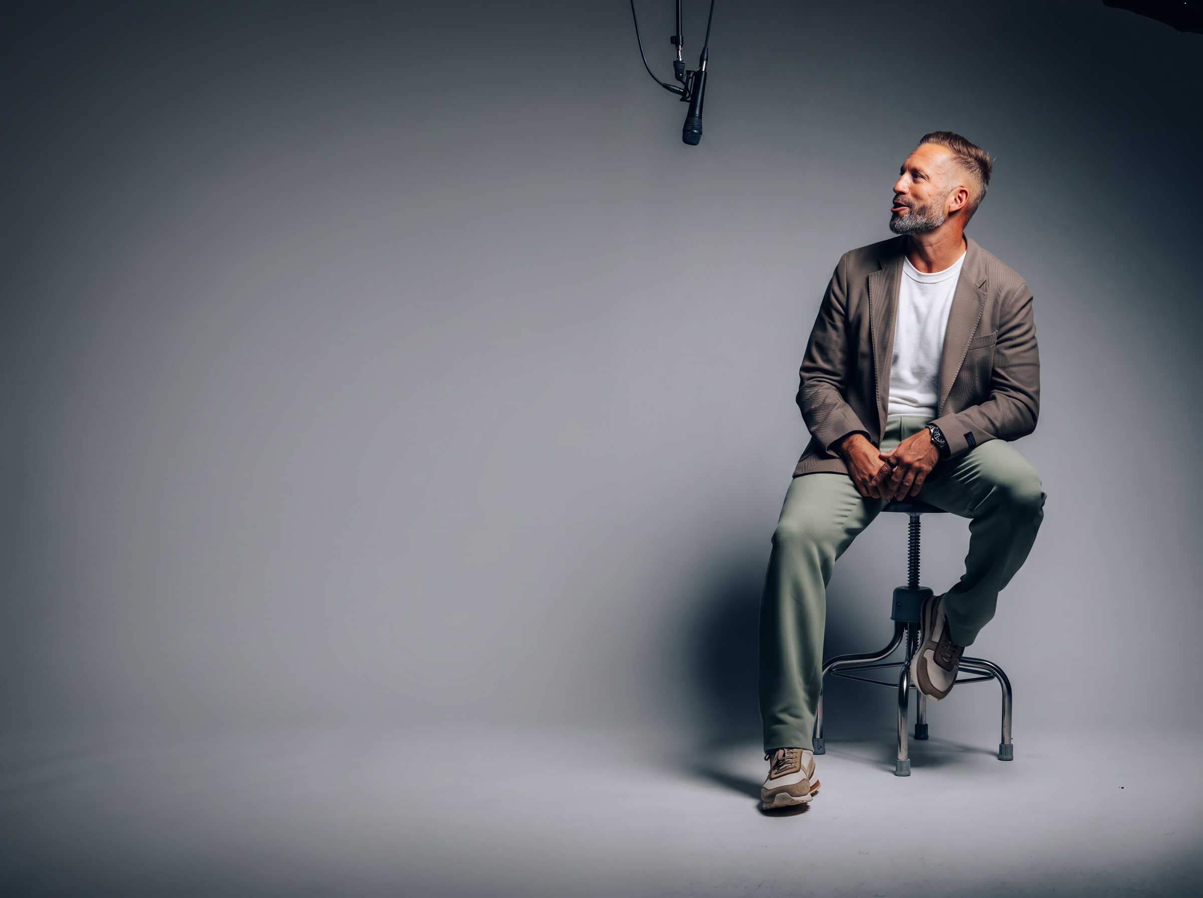 Seb Terry seated on a stool in a studio