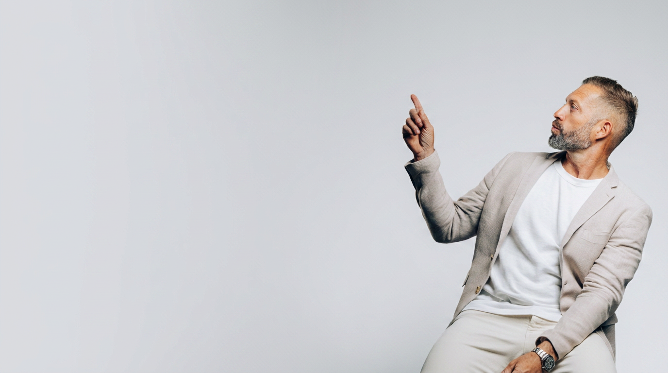 Seb pointing upward in a studio portrait