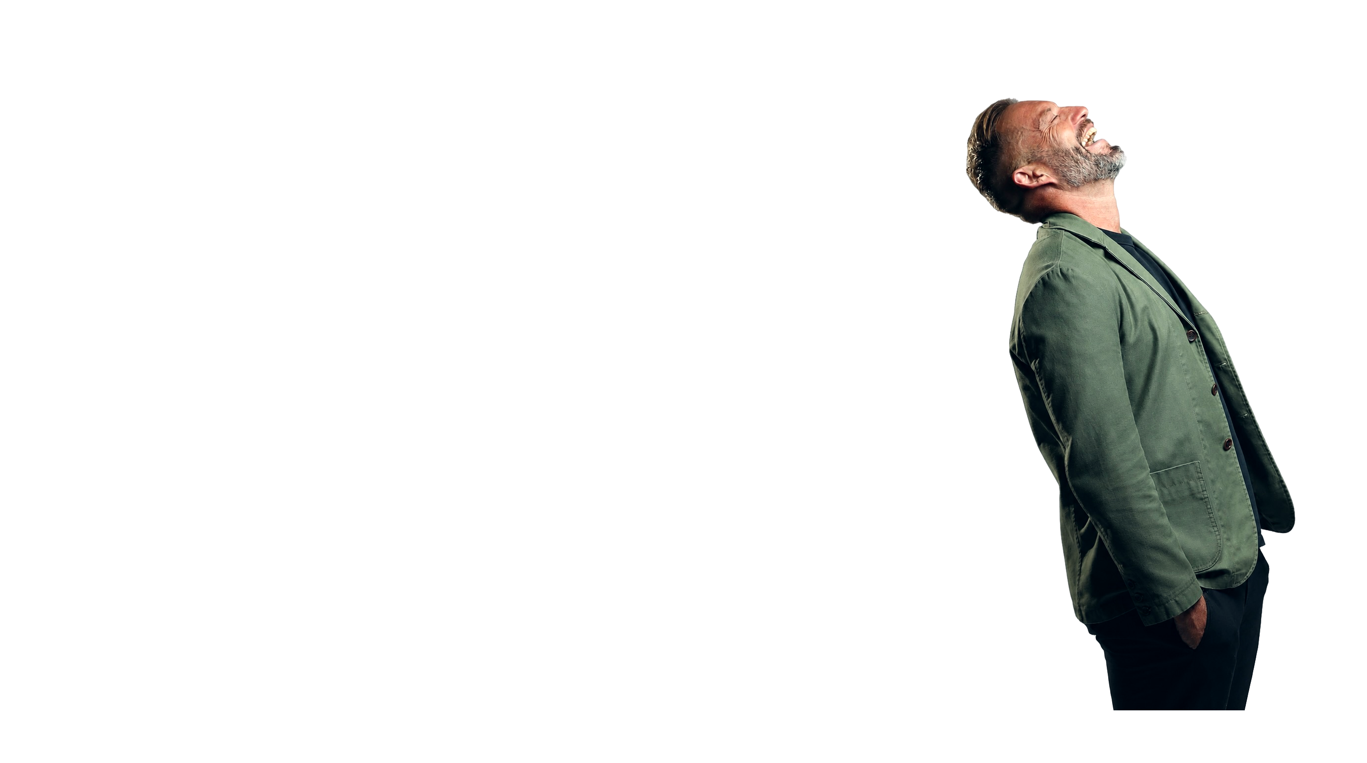 Seb Terry laughing in a green jacket against a studio backdrop